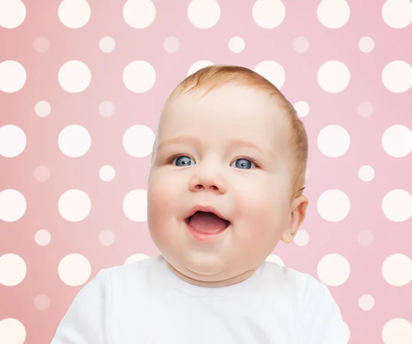 Sorridente bebê menina rosto sobre rosa bolinhas — Fotografia de Stock