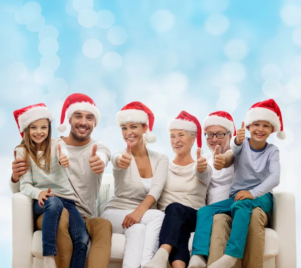 Happy family sitting on couch — Stock Photo, Image