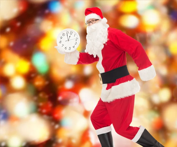 Man in costume of santa claus with clock — Stock Photo, Image