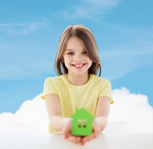 Beautiful little girl holding paper house cutout — Stock Photo, Image