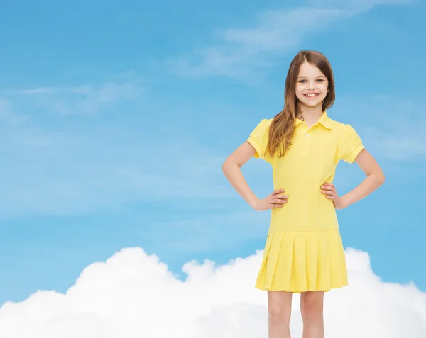 Smiling little girl in yellow dress — Stock Photo, Image