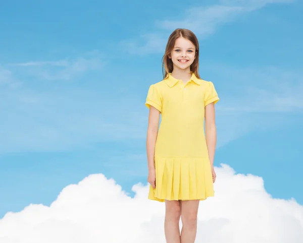 Smiling little girl in yellow dress — Stock Photo, Image