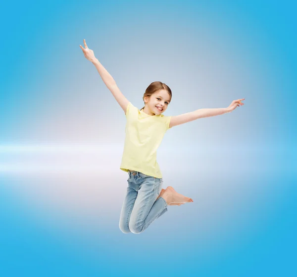 Smiling little girl jumping — Stock Photo, Image