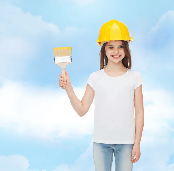 Smiling little girl in helmet with paint brush — Stock Photo, Image