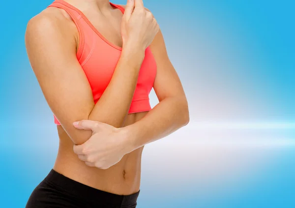 Sporty woman with pain in elbow — Stock Photo, Image