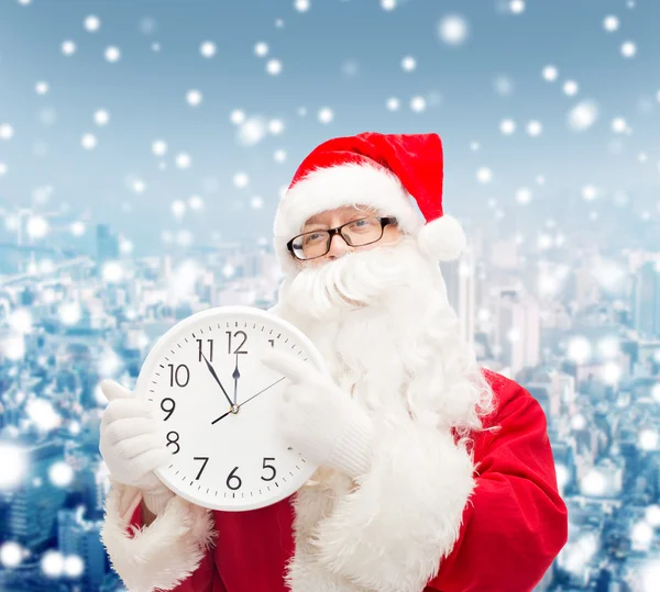 Man in costume of santa claus with clock — Stock Photo, Image