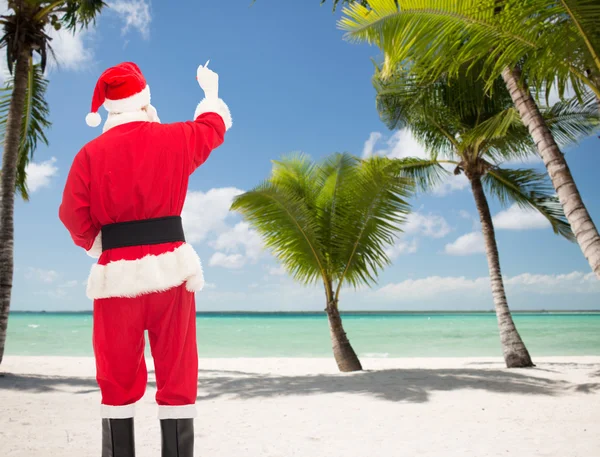 Homem em traje de santa claus escrevendo algo — Fotografia de Stock