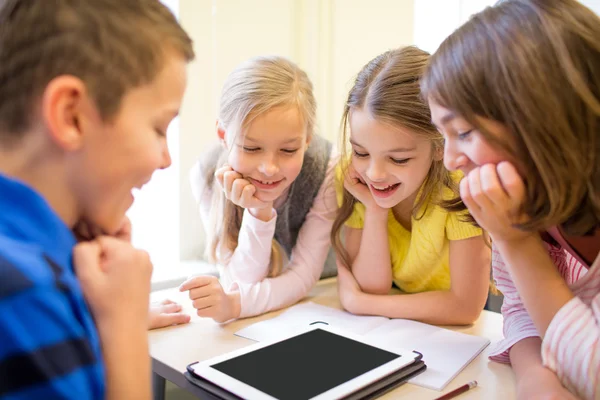 Group of school kids with tablet pc in classroom — Stock Photo, Image