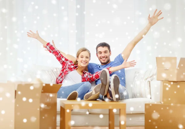 Smiling couple relaxing and waving hand at home — Stock Photo, Image