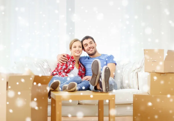 Smiling couple relaxing on sofa in new home — Stock Photo, Image