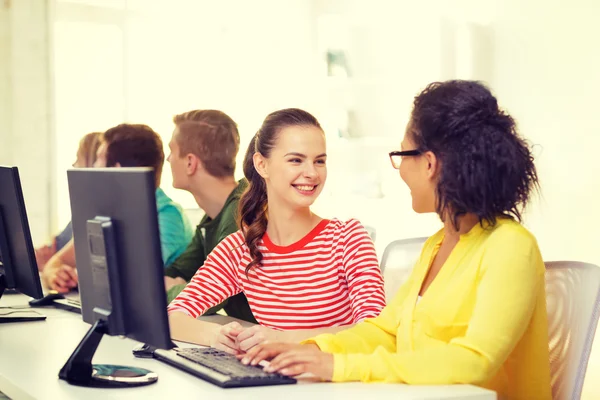 Smiling students in computer class at school — Stock Photo, Image