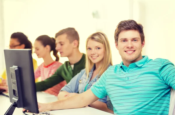 Male student with classmates in computer class Stock Image