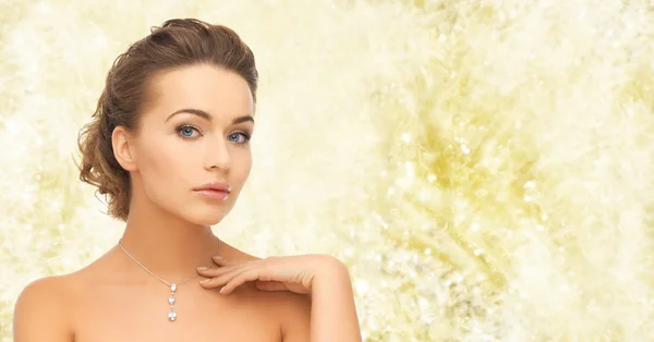 Beautiful woman wearing shiny diamond pendant — Stock Photo, Image