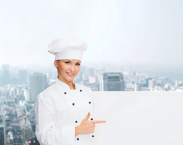 Smiling female chef with white blank board — Stock Photo, Image