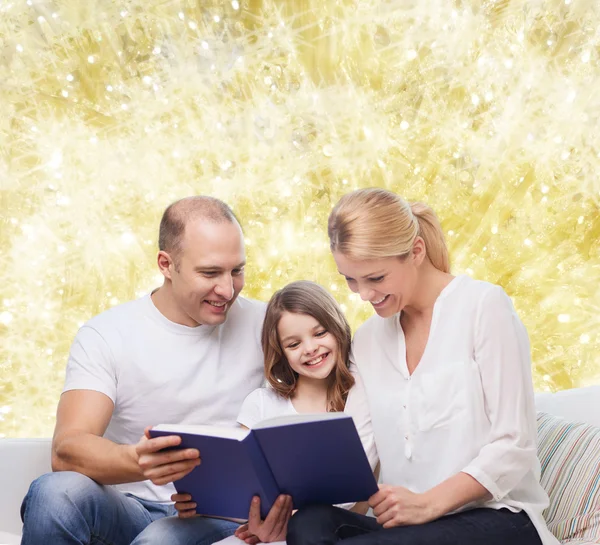 Happy family with book at home — Stock Photo, Image