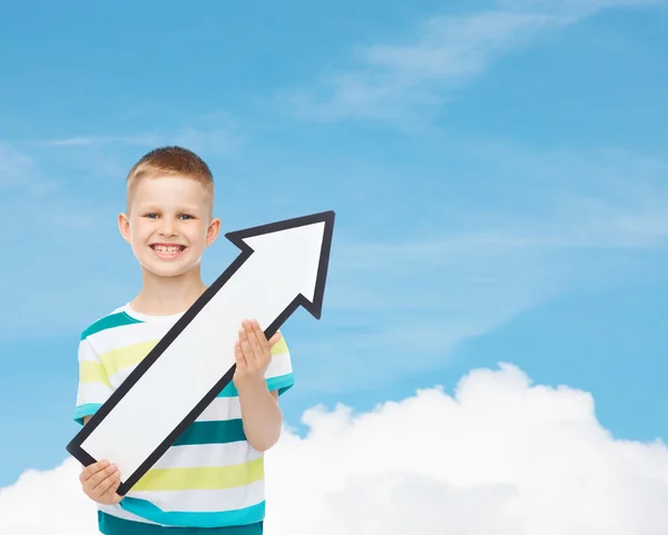 Smiling little boy with blank arrow pointing right — Stock Photo, Image