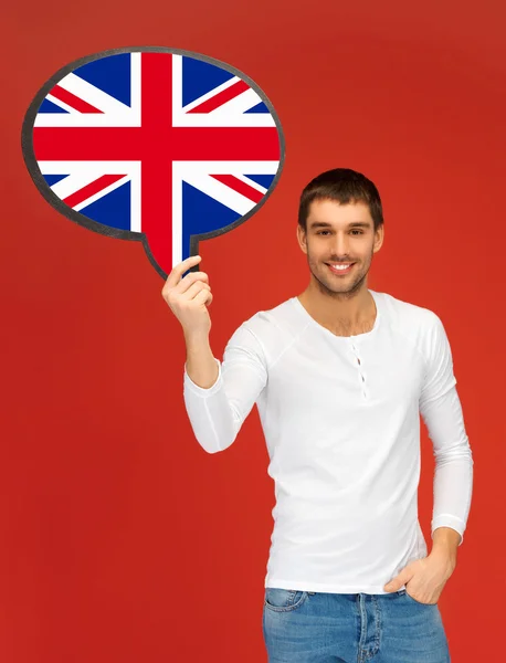 Smiling man with text bubble of british flag — Stock Photo, Image