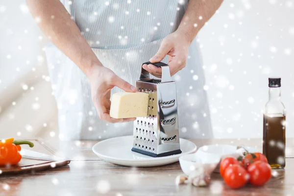 Close up of male hands with grater grating cheese — Stock Photo, Image