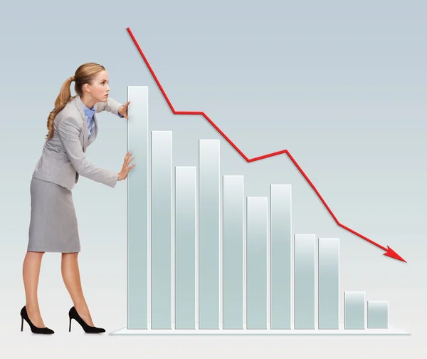 Busy businesswoman pushing graph falling down — Stock Photo, Image