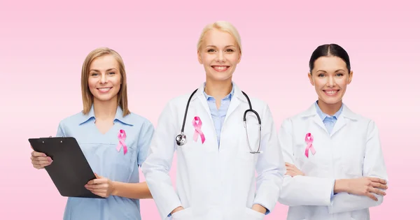 Female doctors with breast cancer awareness ribbon — Stock Photo, Image