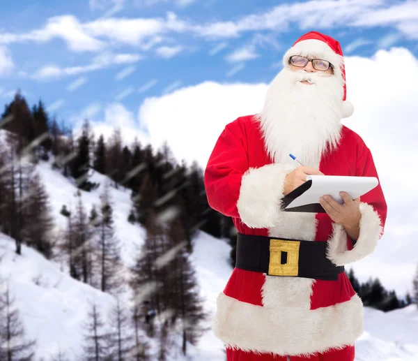 Uomo in costume di Babbo Natale con blocco note — Foto Stock