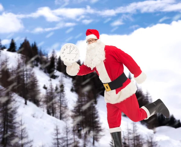 Man in costume of santa claus with clock — Stock Photo, Image