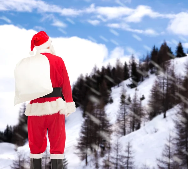 Homme en costume de Père Noël claus avec sac — Photo