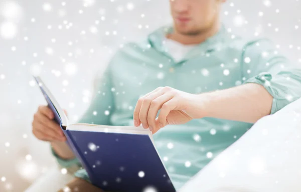 Close up of man reading book at home — Stock Photo, Image