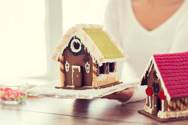 Close up of woman showing gingerbread house — Stock Photo, Image