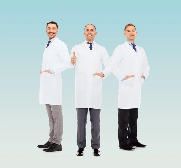 Smiling male doctors in white coats — Stock Photo, Image