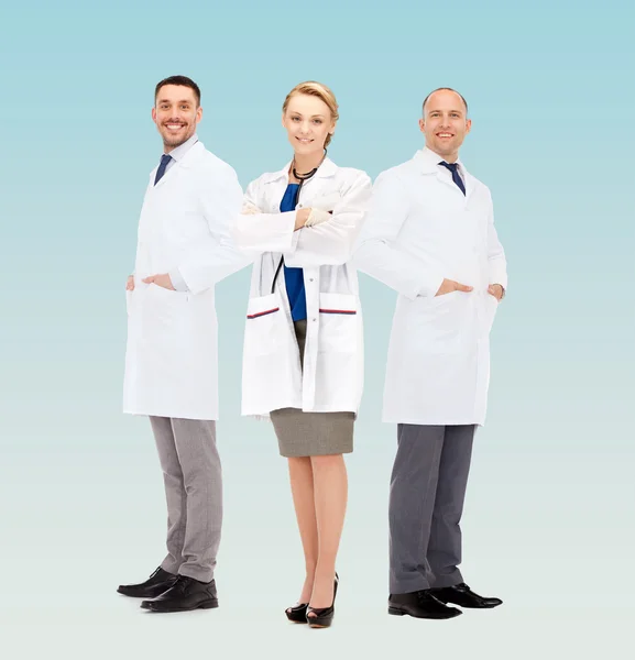 Group of smiling doctors in white coats — Stock Photo, Image