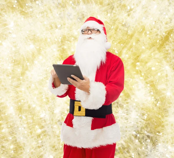 Man in costume of santa claus with tablet pc — Stock Photo, Image