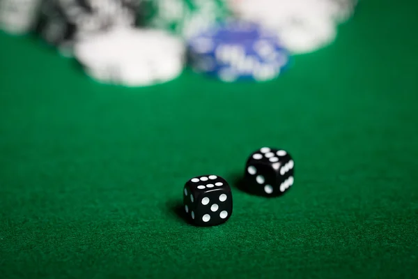 Close up of black dices on green casino table — Stock Photo, Image