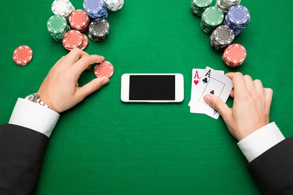 Casino player with cards, smartphone and chips — Stock Photo, Image