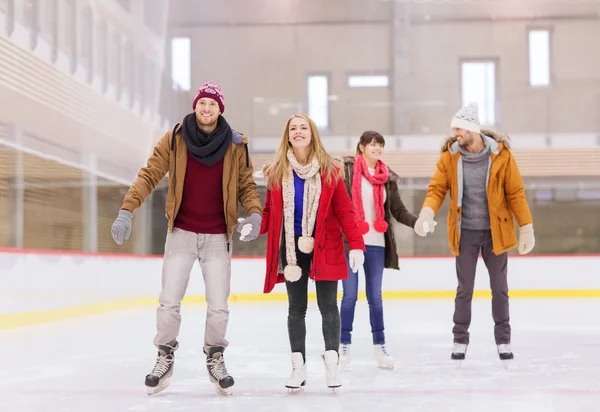 Happy friends on skating rink — Stock Photo, Image