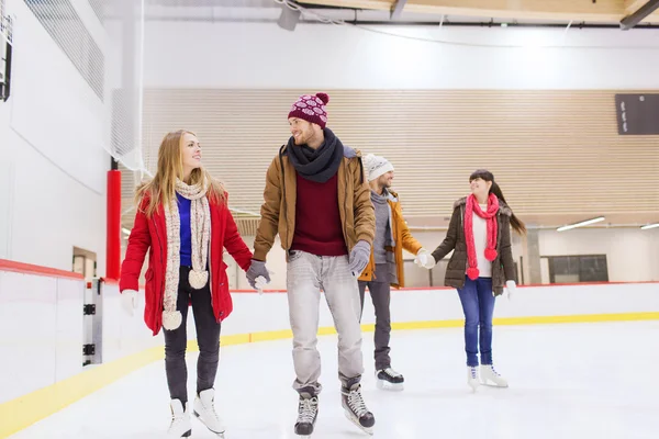 Happy friends on skating rink — Stock Photo, Image