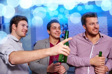 group of male friends with beer in nightclub clipart