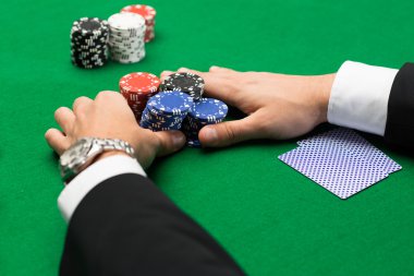 poker player with cards and chips at casino clipart