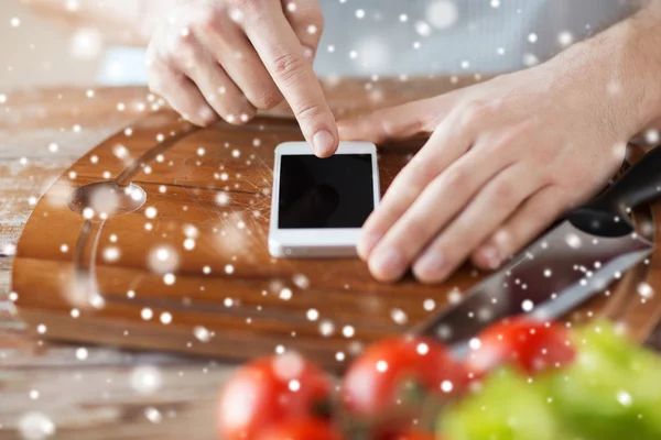 Close up of man reading recipe from smartphone — Stock Photo, Image