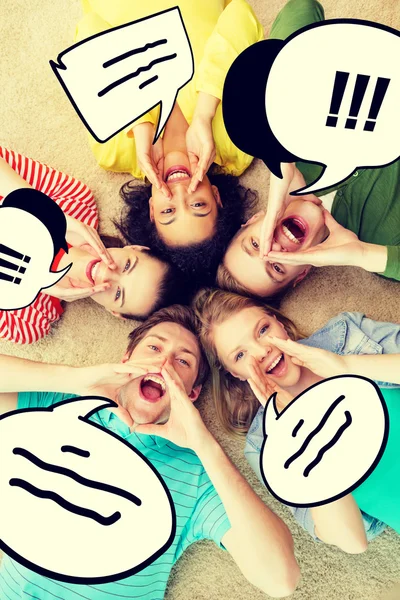 Smiling people lying down on floor and screaming — Stock Photo, Image