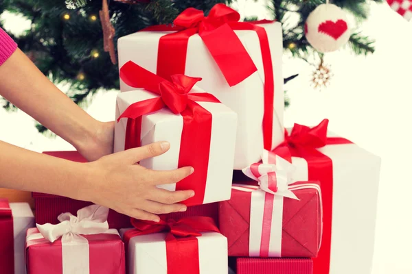 Close up of woman with presents and christmas tree — Stock Photo, Image