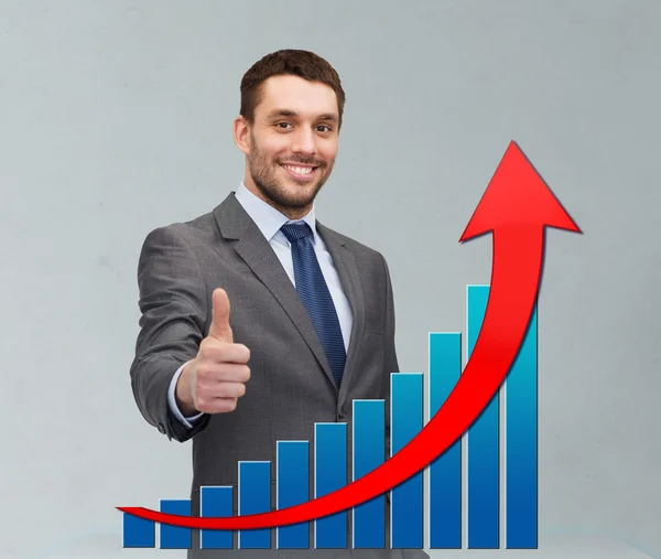 Smiling young businessman showing thumbs up — Stock Photo, Image