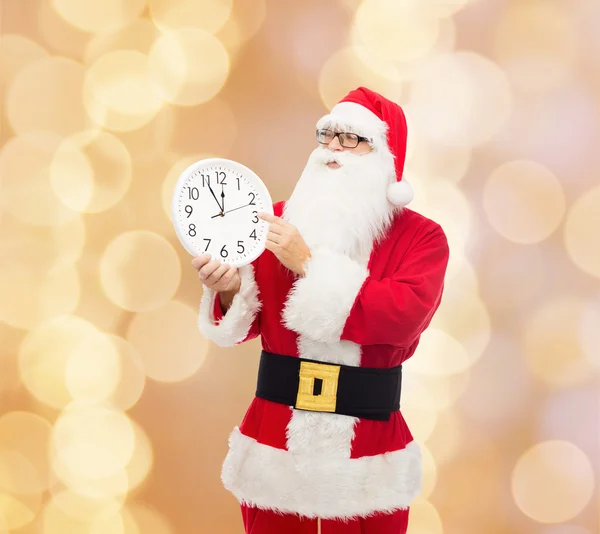 Man in costume of santa claus with clock — Stock Photo, Image