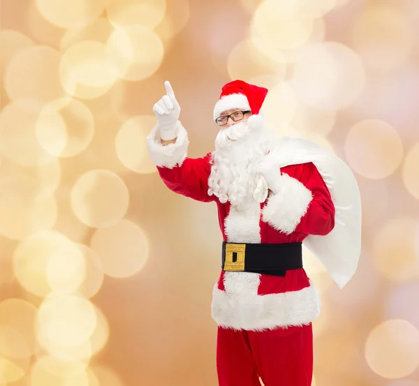 Homme en costume de Père Noël claus avec sac — Photo