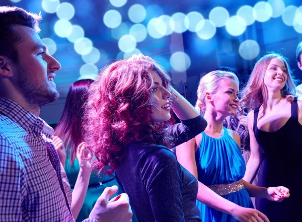 Smiling friends dancing in club Royalty Free Stock Photos