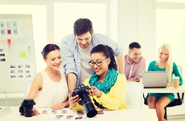 Team sorridente con fotocamera che lavora in ufficio — Foto Stock