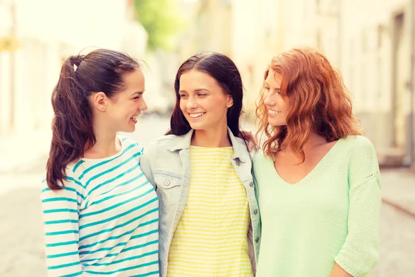 Smiling teenage girls with on street — Stock Photo, Image