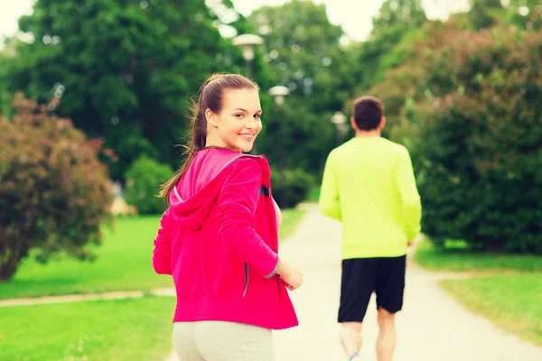 Couple souriant courant à l'extérieur — Photo