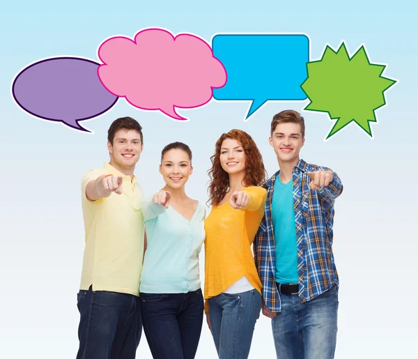 Group of smiling teenagers with text bubbles — Stock Photo, Image