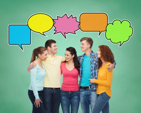 Group of smiling teenagers with text bubbles — Stock Photo, Image